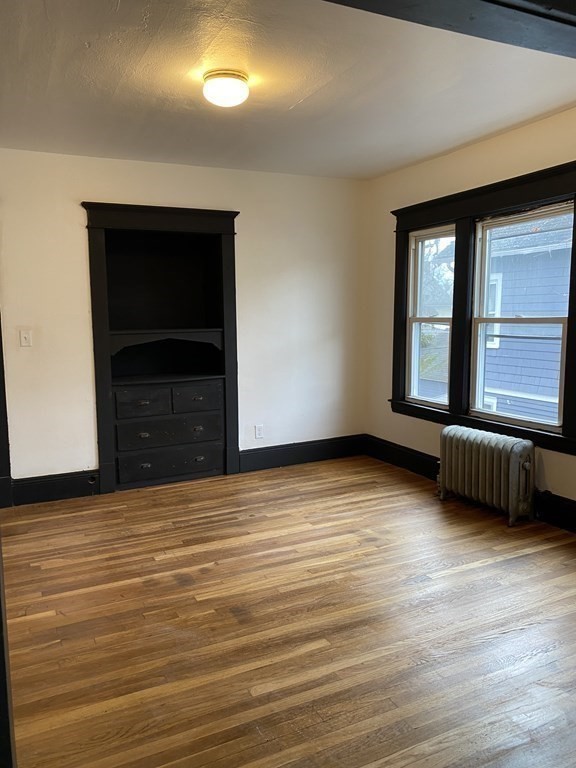 41-43 Lester Street Springfield, MA 01108 - Photo 20 of 25 a view of an empty room with wooden floor and a window