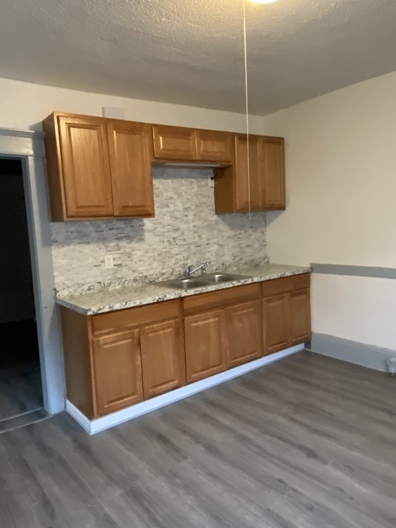 41-43 Lester Street Springfield, MA 01108 - Photo 4 of 25 a kitchen with kitchen island granite countertop wooden cabinets and a sink
