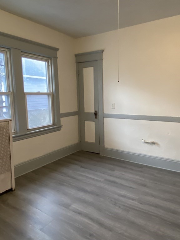 41-43 Lester Street Springfield, MA 01108 - Photo 5 of 25 an empty room with wooden floor and windows