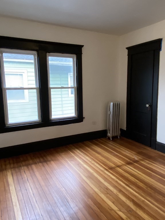 41-43 Lester Street Springfield, MA 01108 - Photo 9 of 25 an empty room with wooden floor and windows
