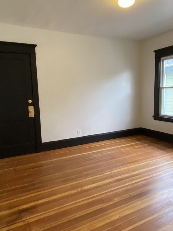 41-43 Lester Street Springfield, MA 01108 - Photo 10 of 25 a view of an empty room with wooden floor and a window
