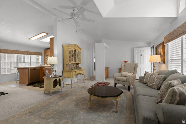 2600 North Hill Field Road, Unit 134 Layton, UT 84041 - Photo 1 of 41 Living room featuring light carpet, vaulted ceiling, and a ceiling fan