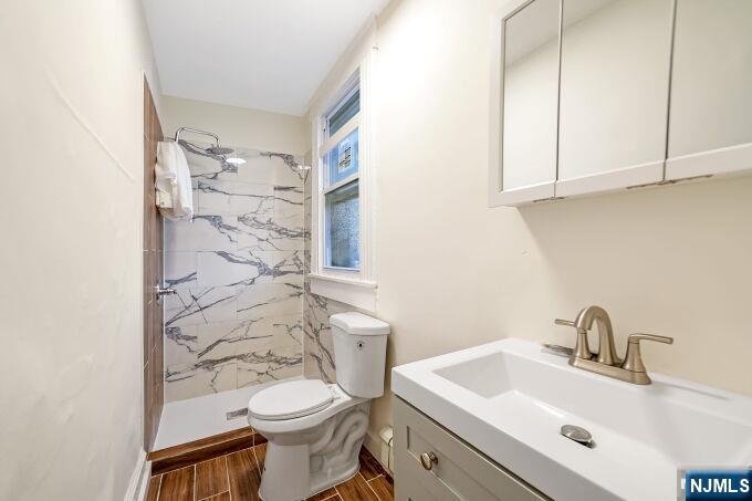 743 Harrison Avenue Harrison, NJ 07029 - Photo 16 of 50 a bathroom with a sink a toilet and shower