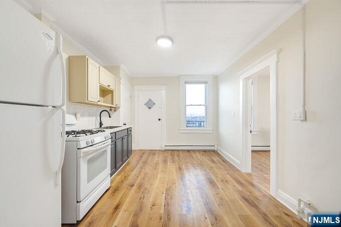 743 Harrison Avenue Harrison, NJ 07029 - Photo 17 of 50 a kitchen with a sink wooden floor and stainless steel appliances