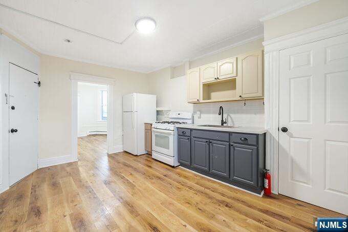 743 Harrison Avenue Harrison, NJ 07029 - Photo 19 of 50 a large white kitchen with a sink window and stainless steel appliances