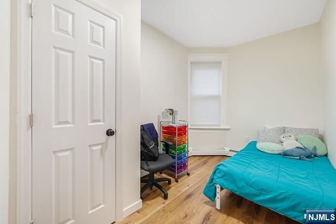 743 Harrison Avenue Harrison, NJ 07029 - Photo 24 of 50 a bedroom with a bed closet and a mirror