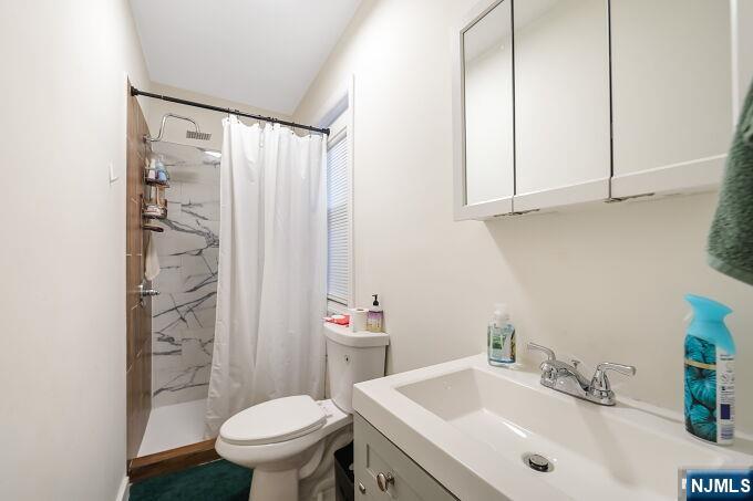 743 Harrison Avenue Harrison, NJ 07029 - Photo 26 of 50 a bathroom with a sink toilet and shower