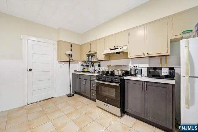 a kitchen with cabinets and stainless steel appliances
