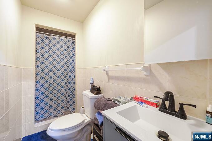 743 Harrison Avenue Harrison, NJ 07029 - Photo 38 of 50 a bathroom with a sink a toilet and a shower