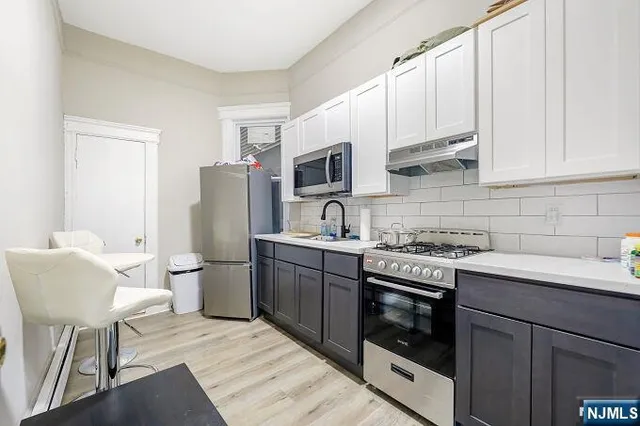 a kitchen with a sink cabinets and stainless steel appliances