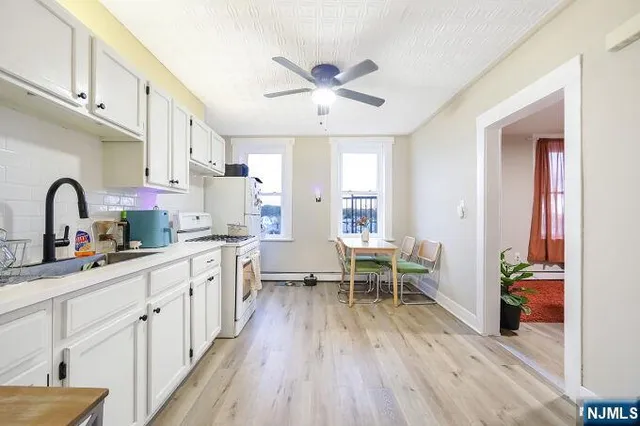 a kitchen with sink cabinets and wooden floor