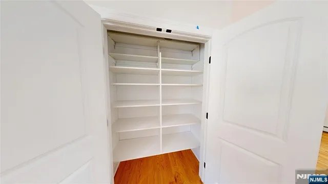 a view of walk in closet with empty racks