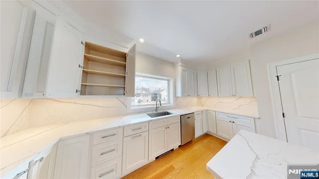 a kitchen that has a sink and cabinets in it