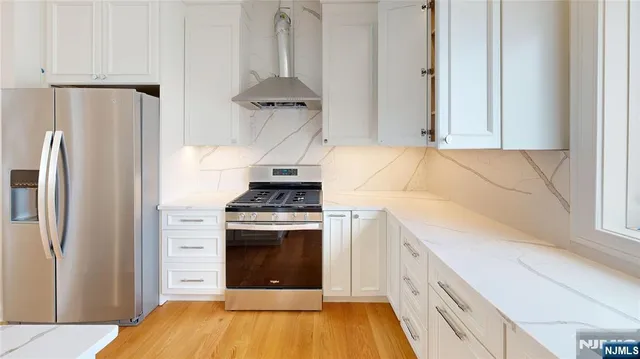 a kitchen with a stove and a refrigerator
