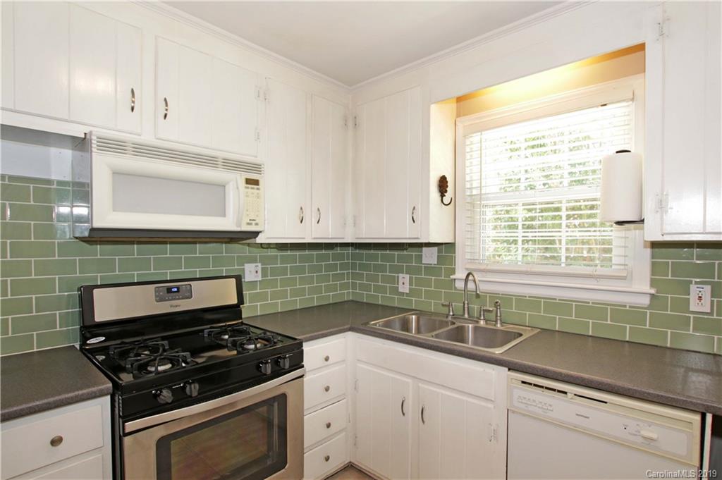 4137 Applegate Road Charlotte, NC 28209 - Photo 15 of 44 a kitchen with granite countertop a sink a stove and cabinets