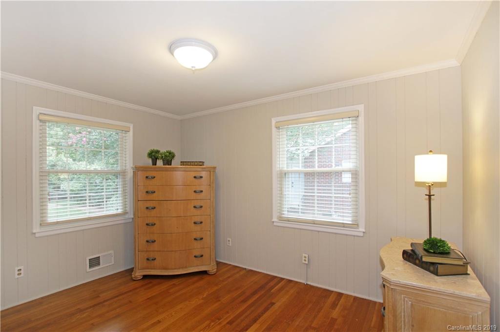 4137 Applegate Road Charlotte, NC 28209 - Photo 16 of 44 a view of a bedroom with a window and a dresser