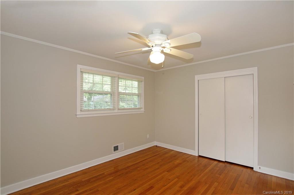 4137 Applegate Road Charlotte, NC 28209 - Photo 23 of 44 an empty room with wooden floor fan and windows