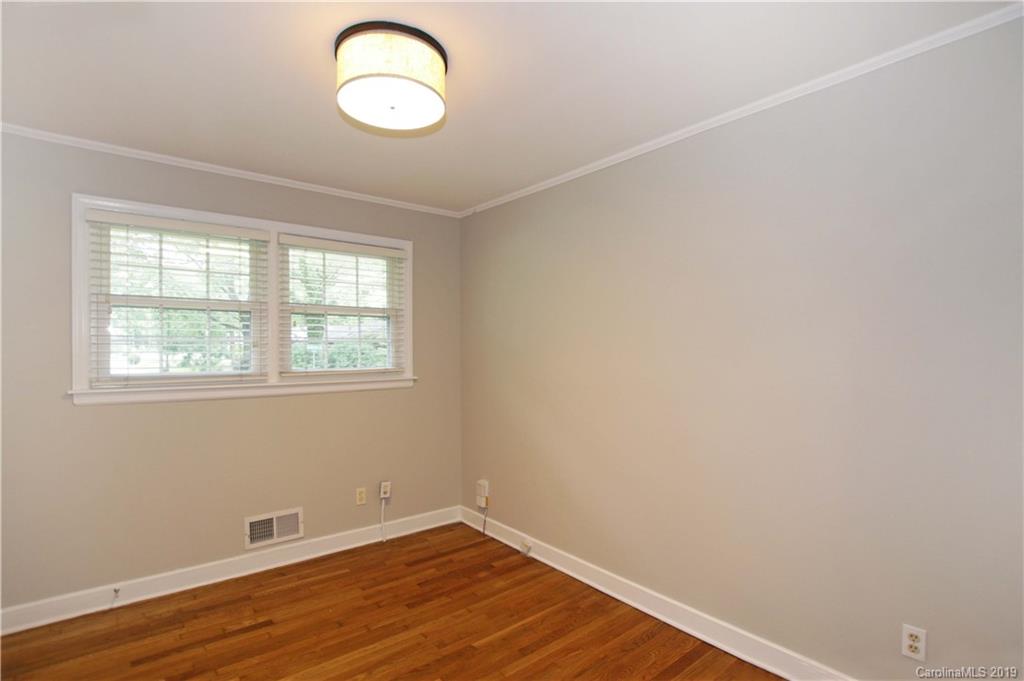 4137 Applegate Road Charlotte, NC 28209 - Photo 24 of 44 an empty room with wooden floor and windows
