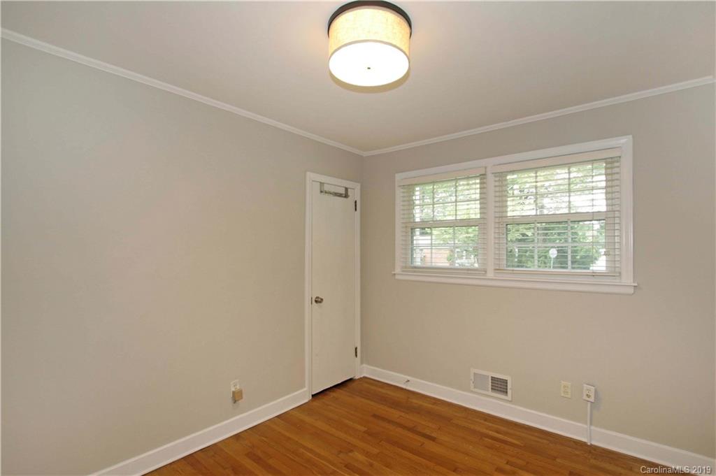 4137 Applegate Road Charlotte, NC 28209 - Photo 26 of 44 an empty room with wooden floor and windows