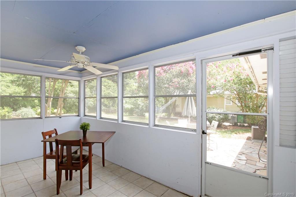 4137 Applegate Road Charlotte, NC 28209 - Photo 27 of 44 a view of a dining room with furniture large windows and wooden floor