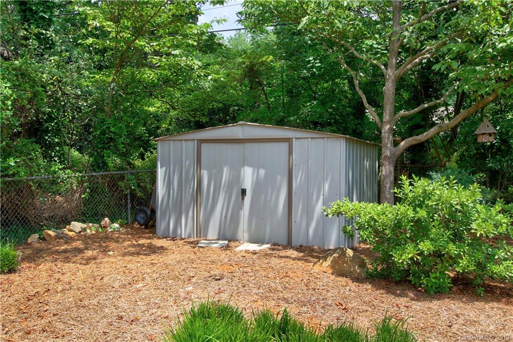 4137 Applegate Road Charlotte, NC 28209 - Photo 33 of 44 a backyard of a house with plants and large trees
