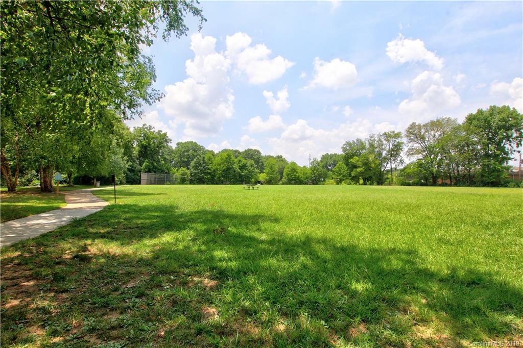 4137 Applegate Road Charlotte, NC 28209 - Photo 39 of 44 a view of a green field with wooden fence