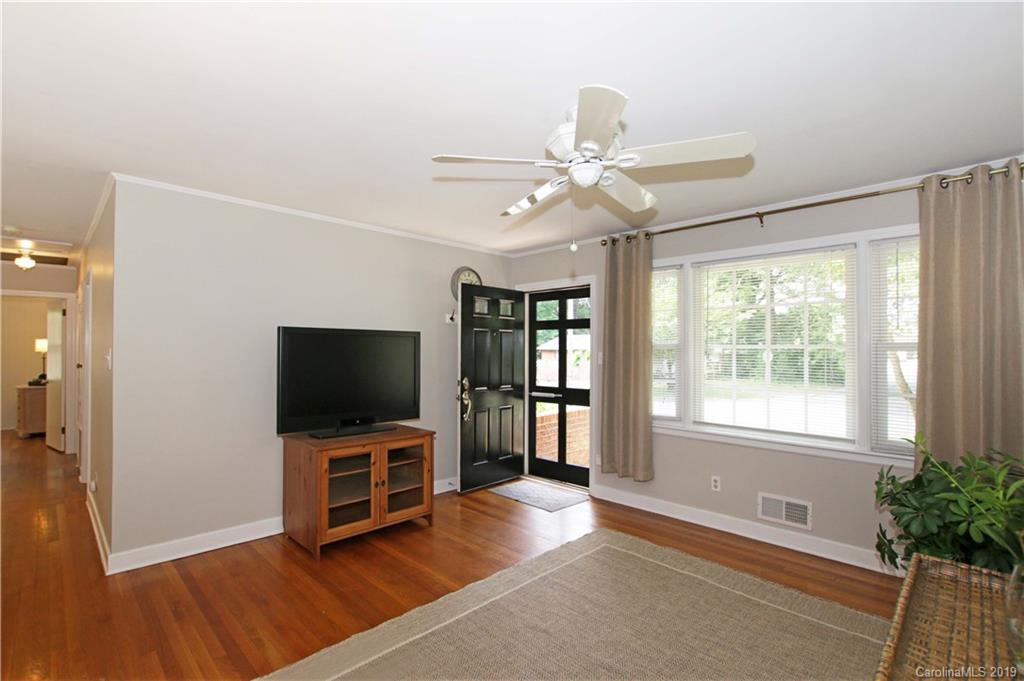 4137 Applegate Road Charlotte, NC 28209 - Photo 5 of 44 a view of a livingroom with a flat screen tv and a ceiling fan
