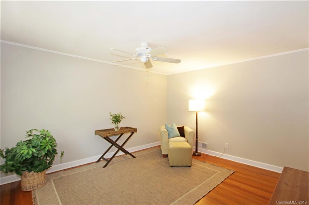 4137 Applegate Road Charlotte, NC 28209 - Photo 6 of 44 a lamp on a table with wooden floor