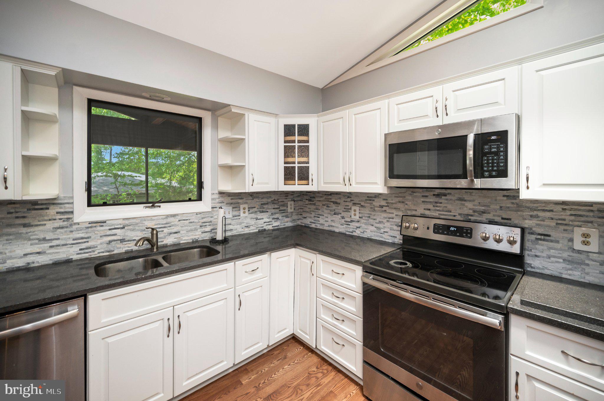 110 Federal Road Locust Grove, VA 22508 - Photo 24 of 77 a kitchen with stainless steel appliances a stove sink and microwave