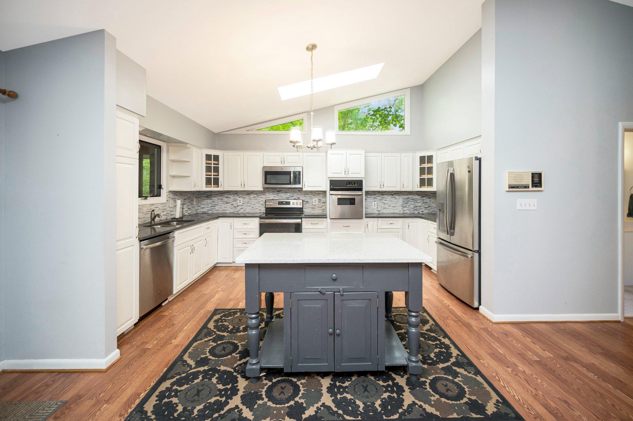 110 Federal Road Locust Grove, VA 22508 - Photo 27 of 77 a kitchen with kitchen island a sink appliances and cabinets