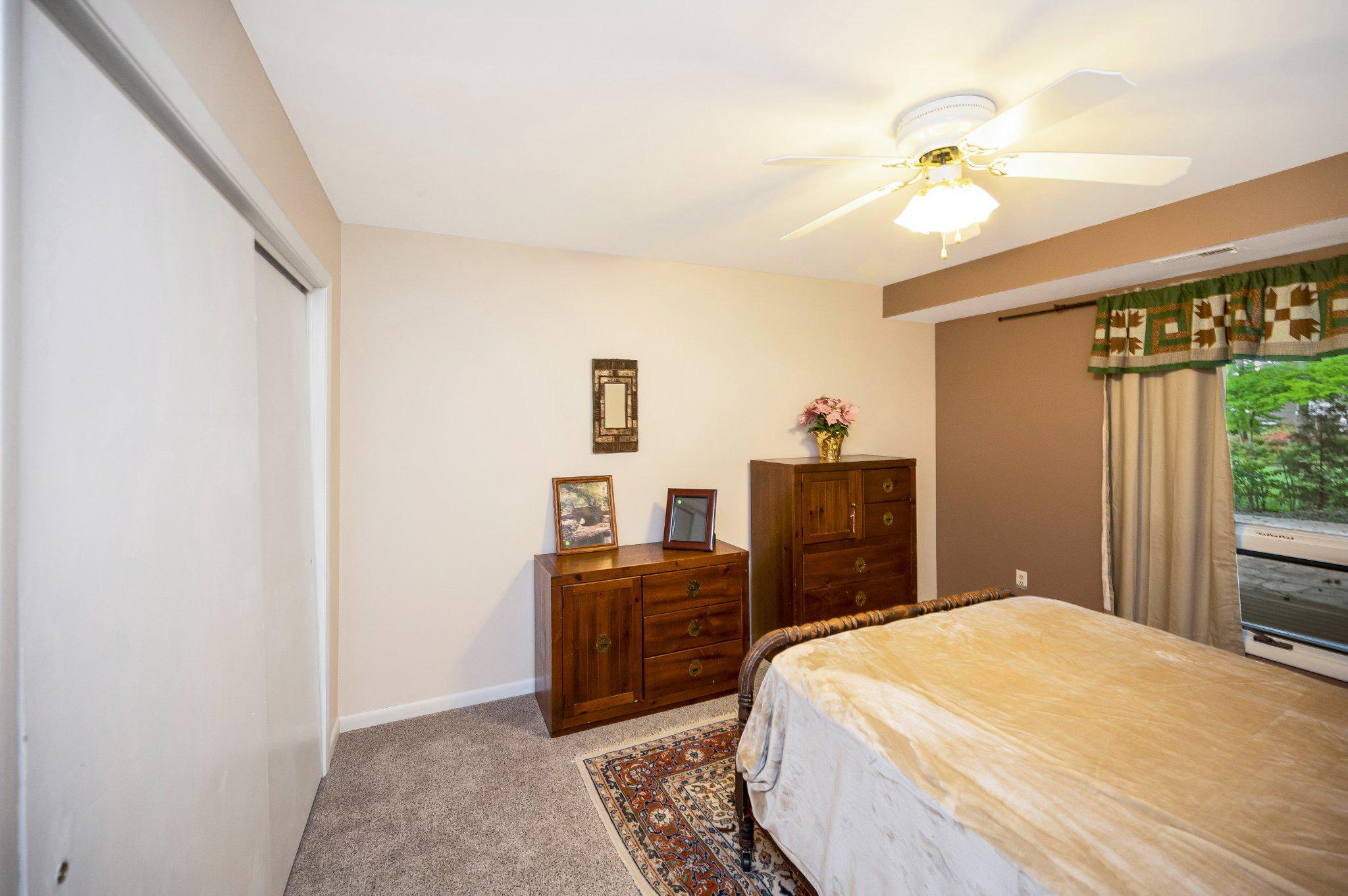 110 Federal Road Locust Grove, VA 22508 - Photo 44 of 77 a bedroom with a bed and a chandelier