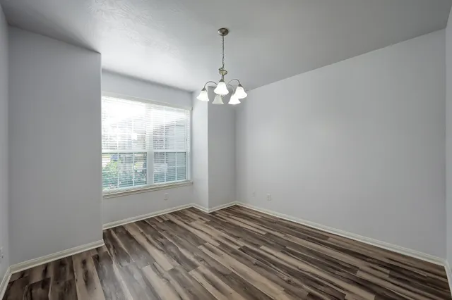 a large kitchen with stainless steel appliances granite countertop a stove refrigerator a sink and dishwasher with wooden cabinets