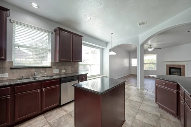 a kitchen that has a sink and a window in it