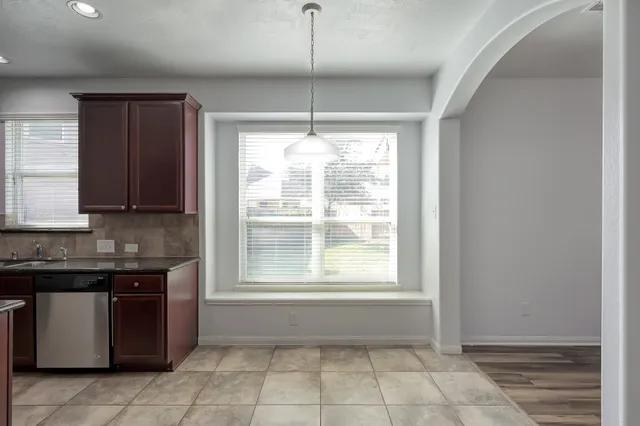 a view of empty room with wooden floor and fireplace