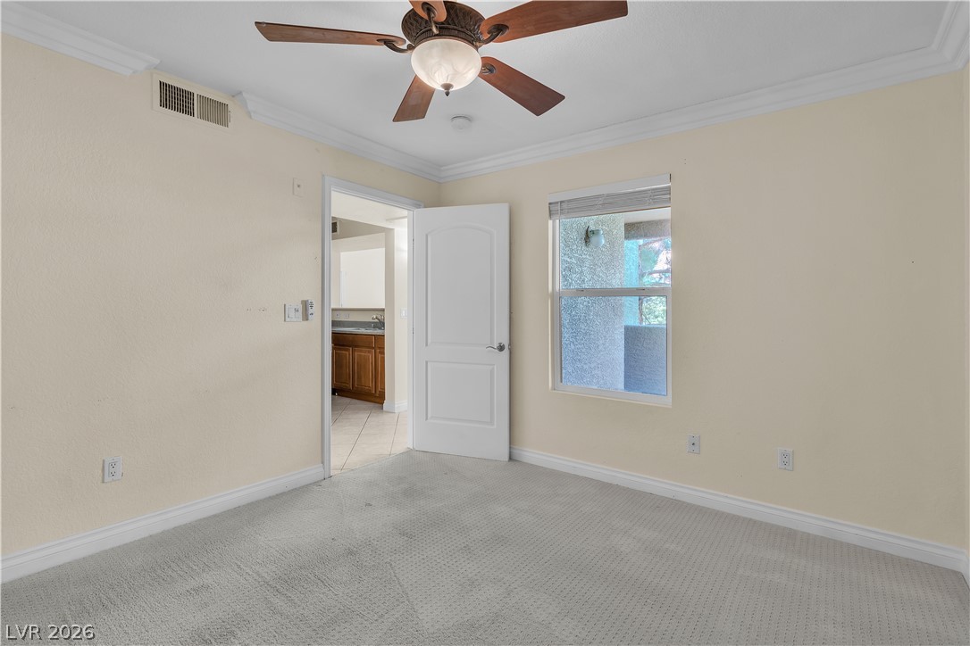 8101 West Flamingo Road, Unit 2001 Las Vegas, NV 89147 - Photo 24 of 28 A well-proportioned room with soft carpet and a window offers a tranquil living space.