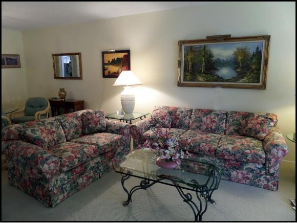 5467 Rattlesnake Hammock Road, Unit 204 Naples, FL 34113 - Photo 2 of 13 a living room with furniture and a couch