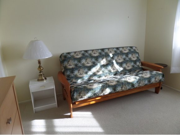 5467 Rattlesnake Hammock Road, Unit 204 Naples, FL 34113 - Photo 11 of 13 a bedroom with a bed and a chair in it