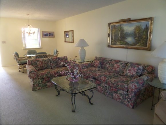 5467 Rattlesnake Hammock Road, Unit 204 Naples, FL 34113 - Photo 8 of 13 a living room with furniture and a window