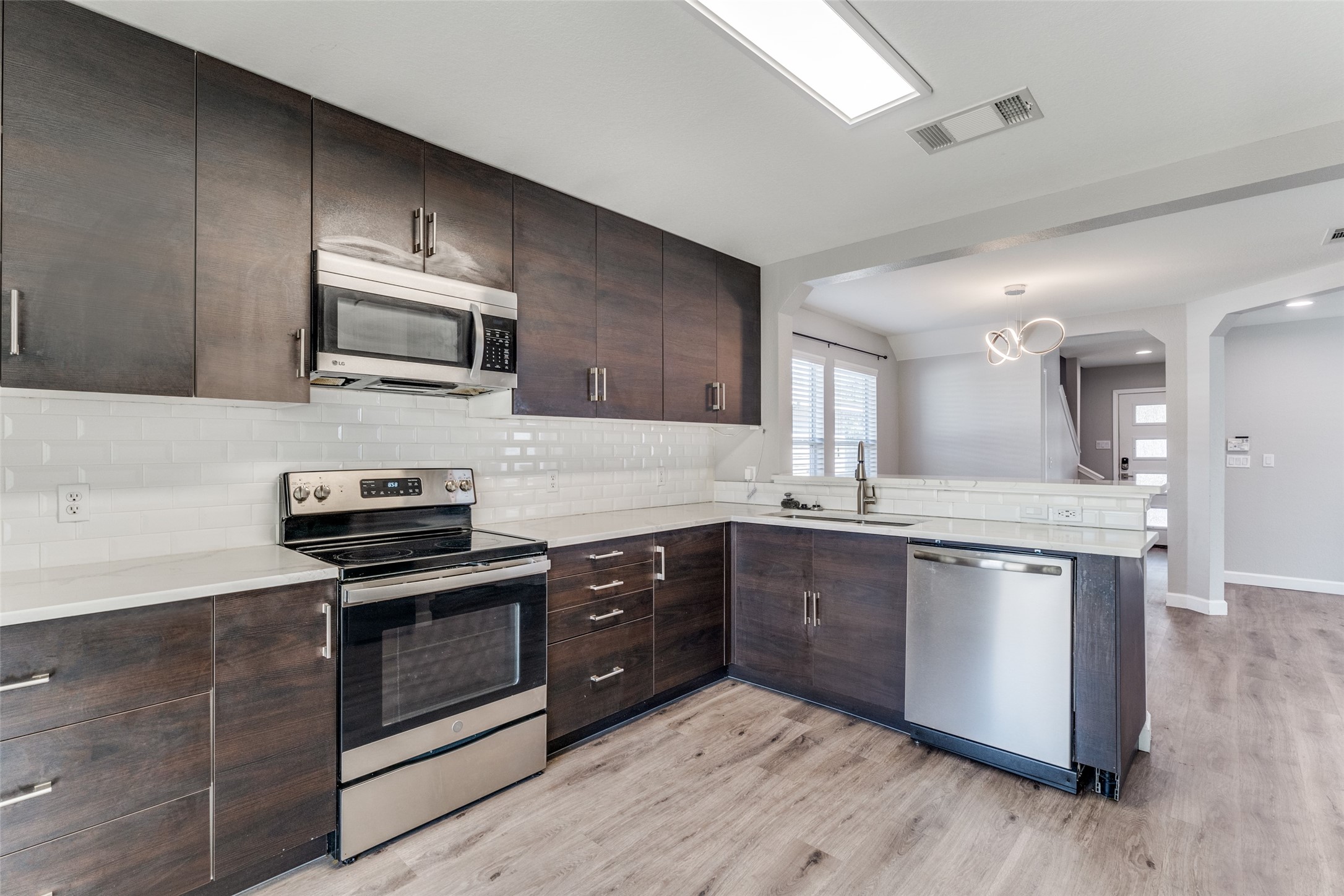 1408 Poppy Seed Lane Austin, TX 78741 - Photo 1 of 23 a kitchen with stainless steel appliances a stove sink microwave and cabinets