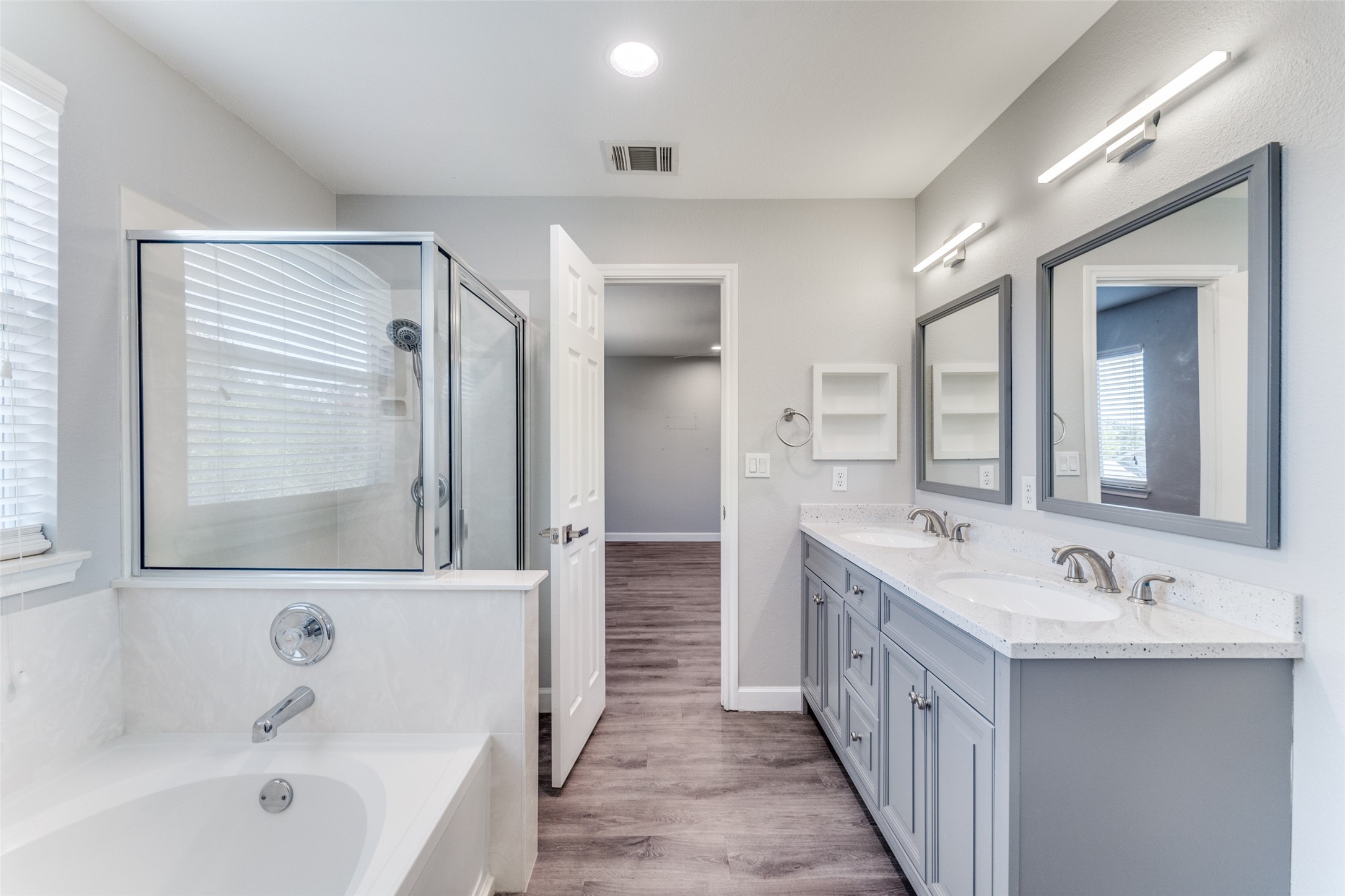 1408 Poppy Seed Lane Austin, TX 78741 - Photo 12 of 23 a bathroom with a double vanity sink mirror and bathtub