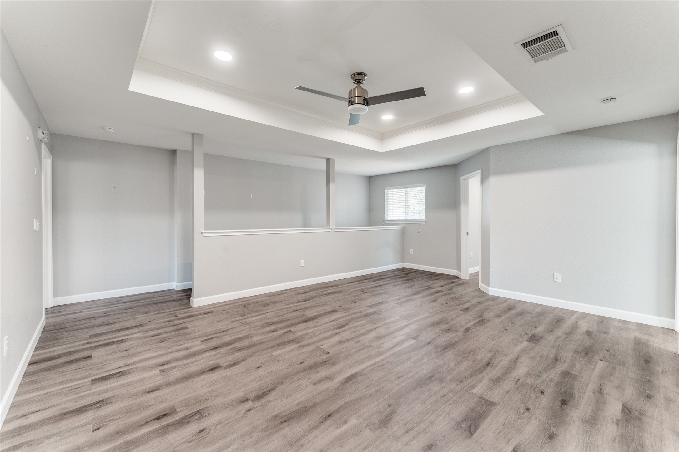 1408 Poppy Seed Lane Austin, TX 78741 - Photo 18 of 23 an empty room with wooden floor ceiling fan and windows