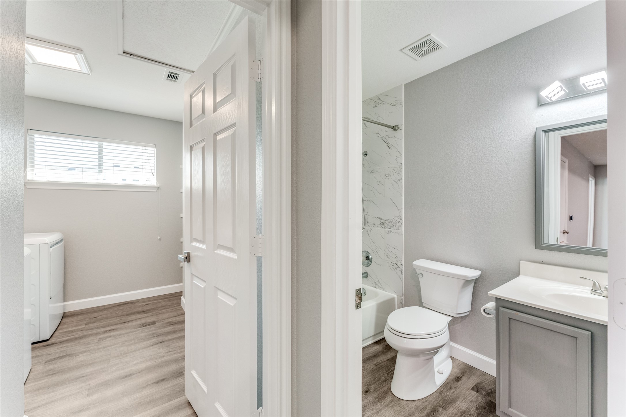 1408 Poppy Seed Lane Austin, TX 78741 - Photo 20 of 23 a bathroom with a toilet sink and a mirror