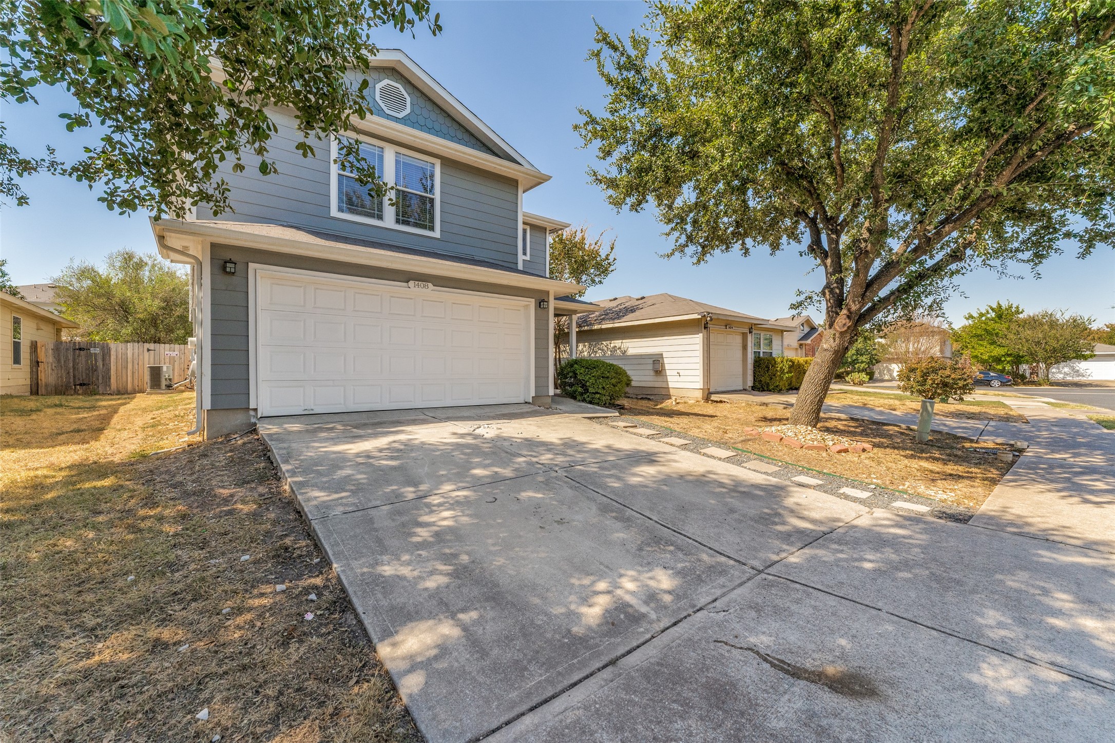 1408 Poppy Seed Lane Austin, TX 78741 - Photo 2 of 23 a front view of a house with a yard and garage