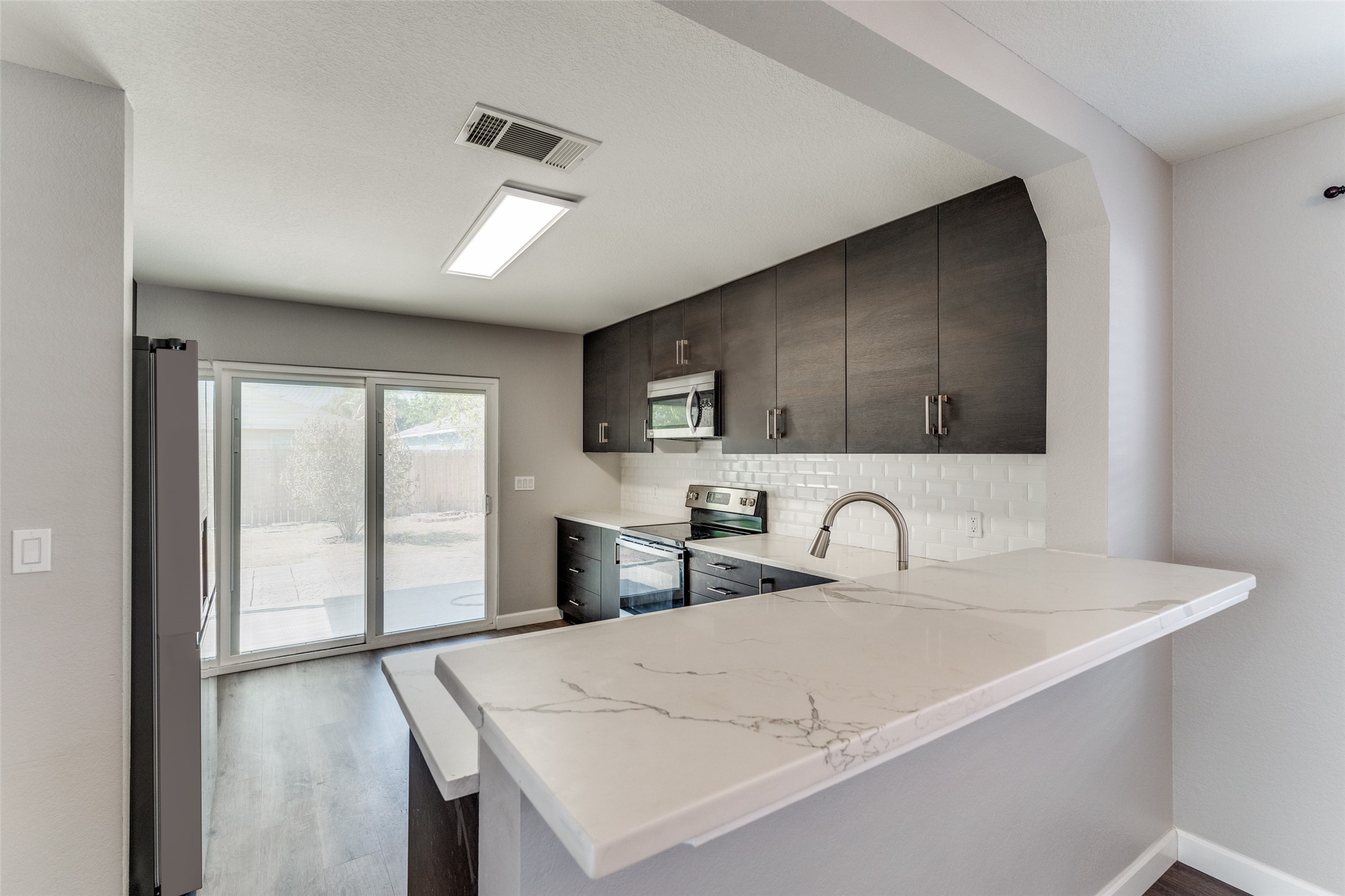 1408 Poppy Seed Lane Austin, TX 78741 - Photo 4 of 23 a kitchen with granite countertop a sink a stove and cabinets