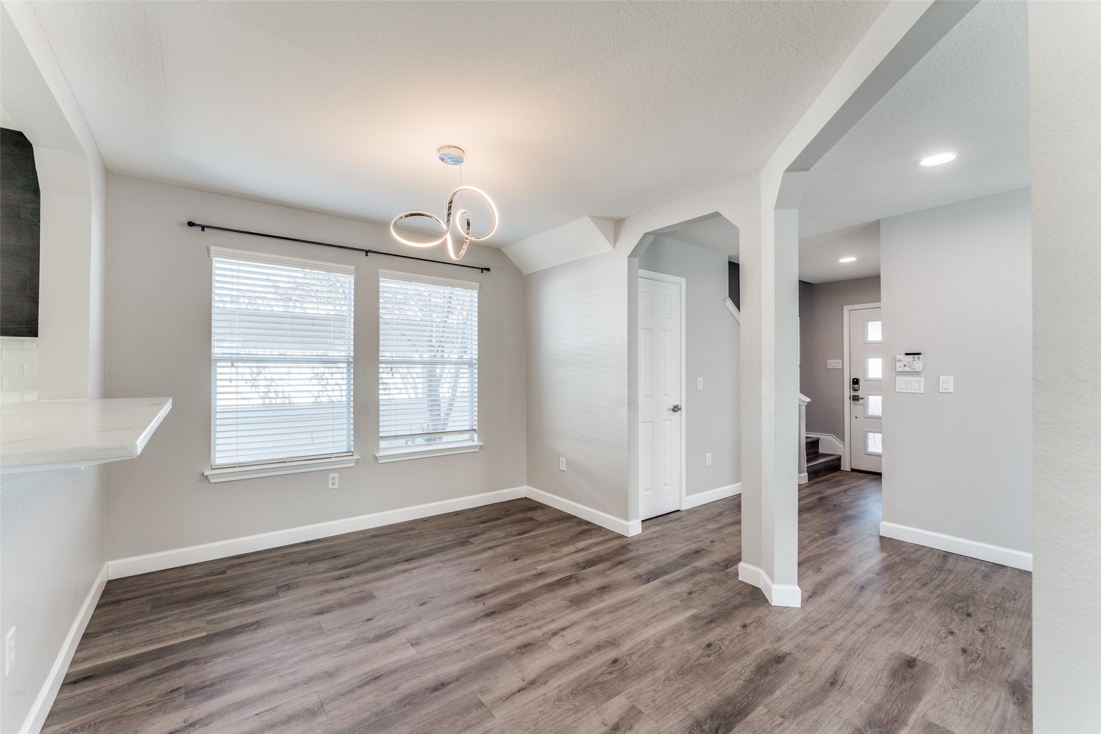 1408 Poppy Seed Lane Austin, TX 78741 - Photo 9 of 23 a view of an empty room with wooden floor and a window