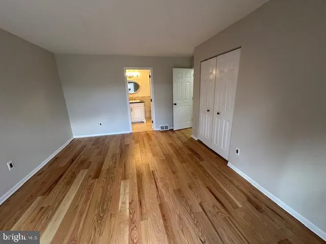 a view of a room with wooden floor and brick walls