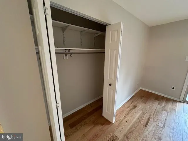 a view of walk in closet with empty room