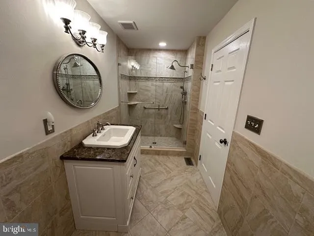 a bathroom with a sink a toilet and a shower