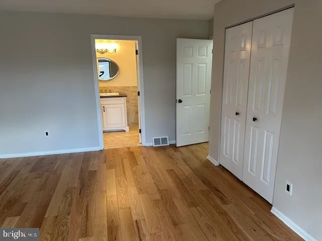 a view of an empty room and wooden floor