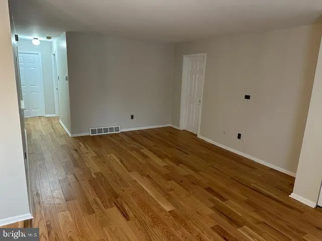 a view of room with wooden floor